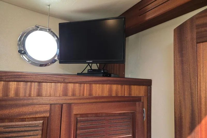 Slide: The Image of TV and porthole in 2010 American Tug "34" Pilothouse Trawler interior. - 14