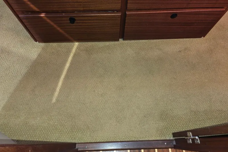 Slide: The Image of Carpeted interior of 2010 American Tug "34" Pilothouse Trawler with wooden cabinetry. - 16