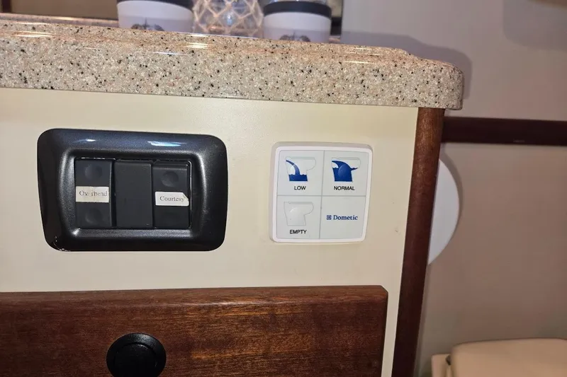 Slide: The Image of Control panel on 2010 American Tug "34" Pilothouse Trawler with switches and Dometic settings. - 19