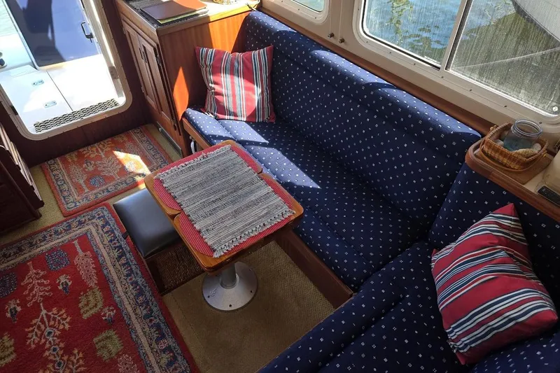 Slide: The Image of Interior of 2010 American Tug "34" Pilothouse Trawler with cozy seating and nautical decor. - 24