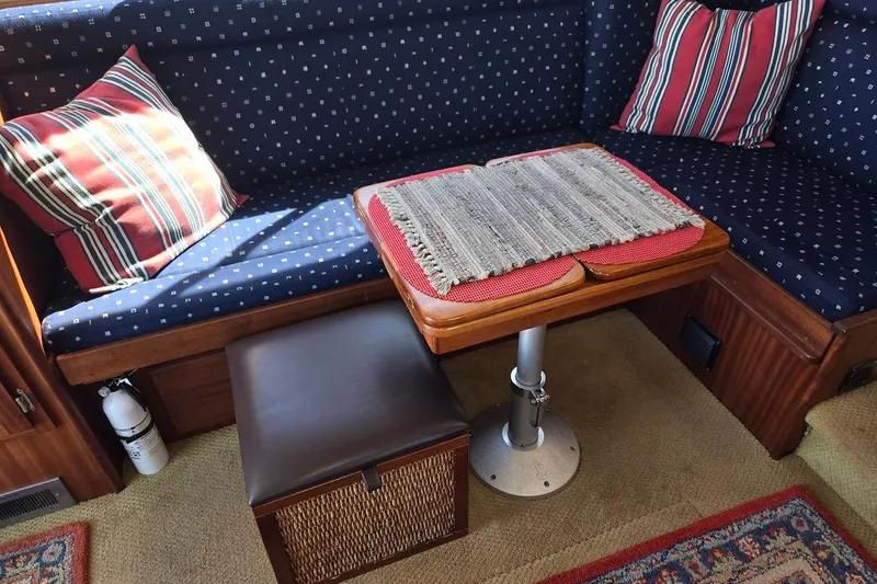 Slide: The Image of Cozy seating area in a 2010 American Tug "34" Pilothouse Trawler with striped cushions. - 26