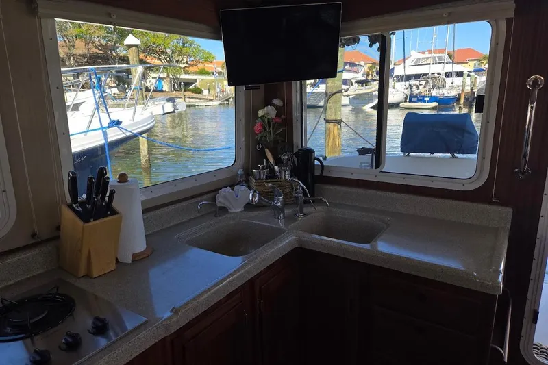 Slide: The Image of Cozy kitchen in 2010 American Tug "34" Pilothouse Trawler with marina view. - 36
