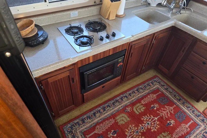 Slide: The Image of Kitchen area of a 2010 American Tug "34" Pilothouse Trawler with stove and microwave. - 39