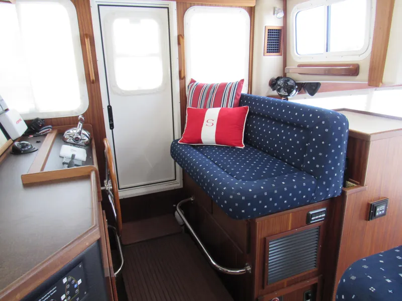 Slide: The Image of Interior of a 2010 American Tug 34 Pilothouse Trawler with blue upholstery. - 44