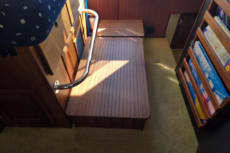 Slide: The Image of Interior of 2010 American Tug "34" Pilothouse Trawler with wooden flooring and storage shelves. - 46