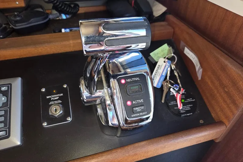 Slide: The Image of Control panel of a 2010 American Tug "34" Pilothouse Trawler with throttle and keys. - 57