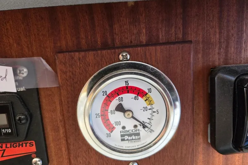 Slide: The Image of Gauge on 2010 American Tug "34" Pilothouse Trawler dashboard, displaying pressure levels. - 63