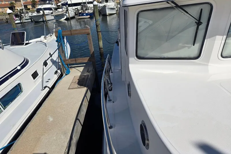 Slide: The Image of 2010 American Tug "34" Pilothouse Trawler docked at marina, side view. - 78