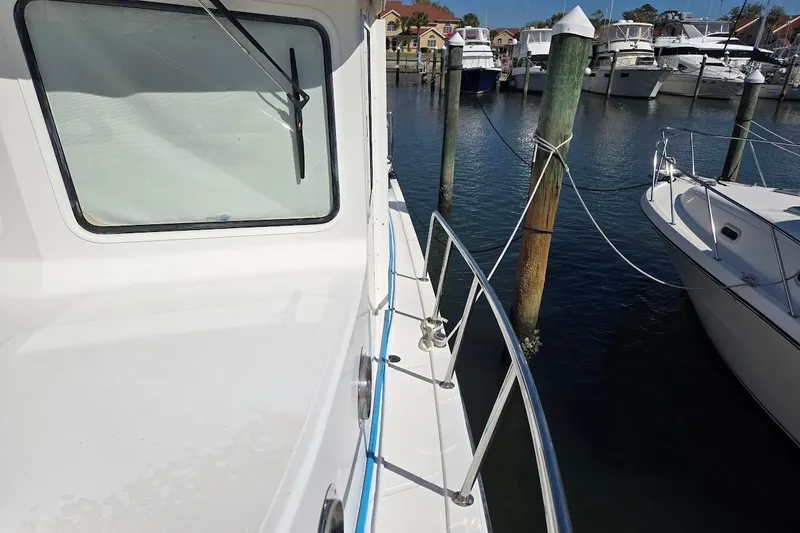 Slide: The Image of 2010 American Tug "34" Pilothouse Trawler docked at marina, side view. - 79