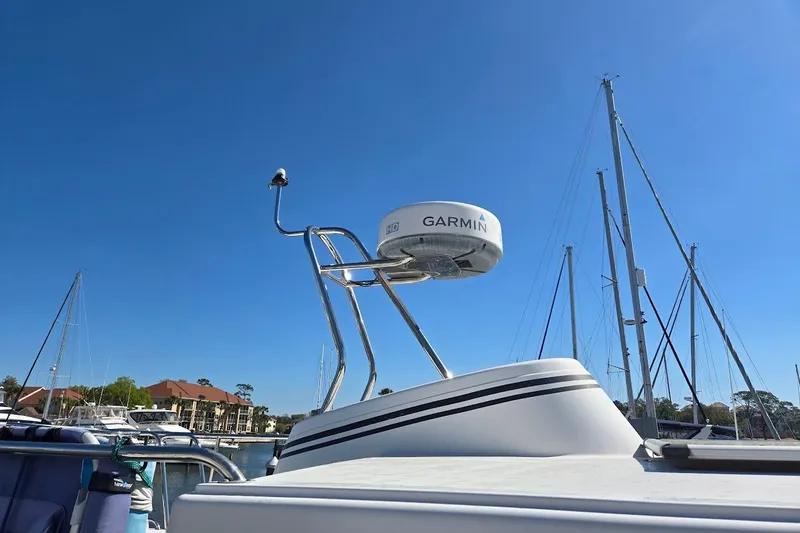 Slide: The Image of 2010 American Tug "34" Pilothouse Trawler with Garmin radar in a marina setting. - 81