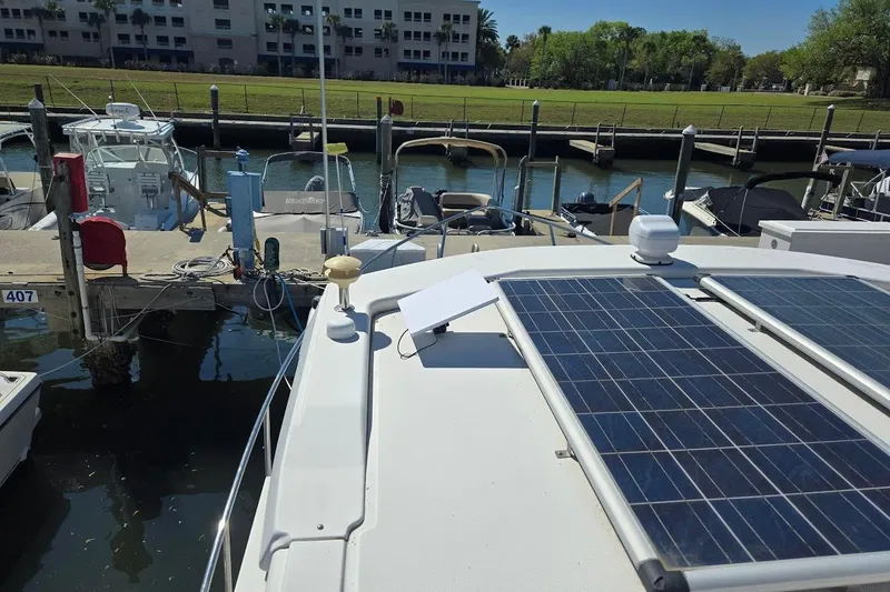 Slide: The Image of 2010 American Tug "34" Pilothouse Trawler with solar panels docked at marina. - 84