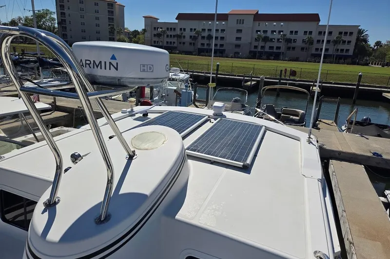 Slide: The Image of 2010 American Tug "34" Pilothouse Trawler with solar panels and Garmin radar at dock. - 85