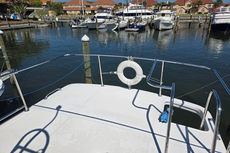 Slide: The Image of American Tug "34" Pilothouse Trawler, 2010, docked in a marina with other boats. - 88
