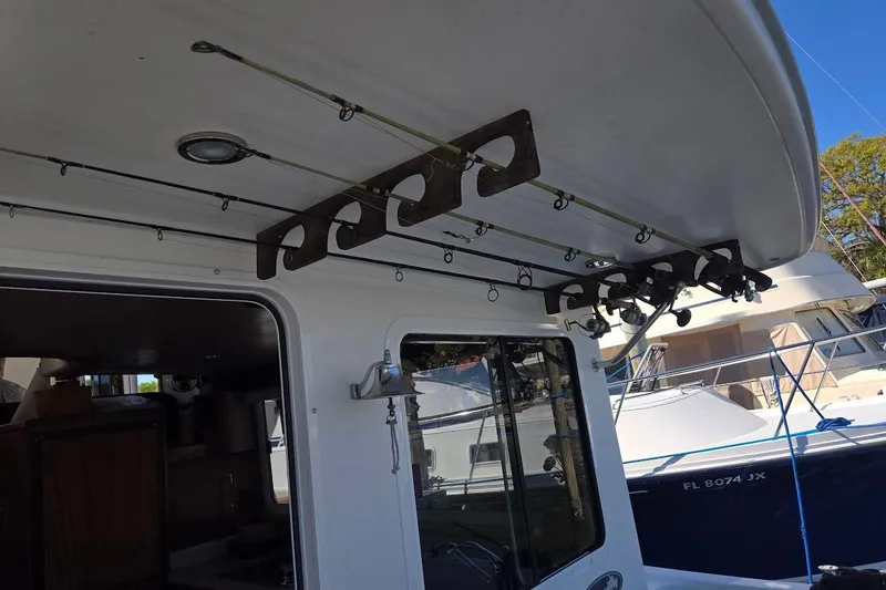 Slide: The Image of 2010 American Tug "34" Pilothouse Trawler with fishing rod holders on deck. - 94