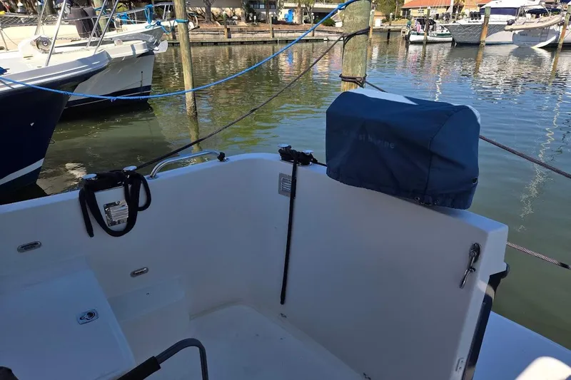 Slide: The Image of 2010 American Tug "34" Pilothouse Trawler docked at marina, featuring covered equipment. - 96