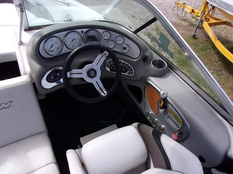 Slide: The Image of 2006 Correct Craft SUPER AIR NAUTIQUE 210 Team Edition boat dashboard and steering wheel. - 5