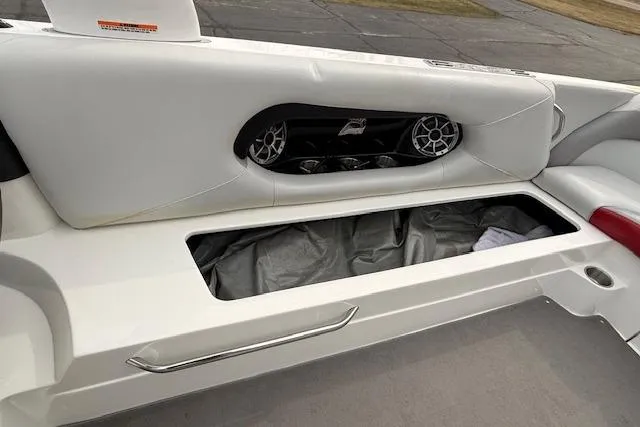 Slide: The Image of 2013 Centurion Enzo SV244 boat interior with storage compartment and speaker system. - 10