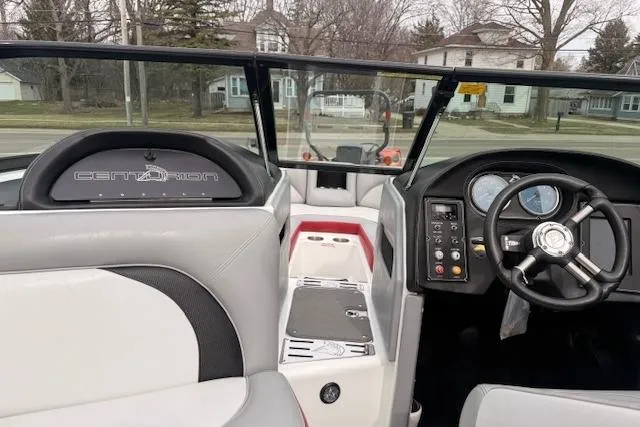 Slide: The Image of 2013 Centurion Enzo SV244 boat interior with steering wheel and dashboard controls. - 12