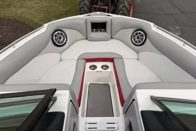 Slide: The Image of 2013 Centurion Enzo SV244 boat interior with cushioned seating and built-in speakers. - 13