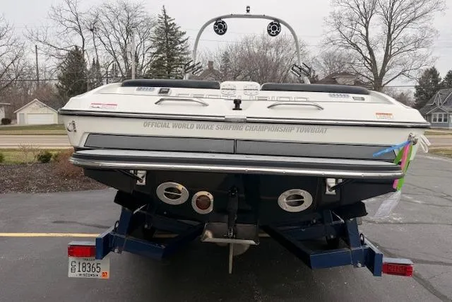 Slide: The Image of 2013 Centurion Enzo SV244 boat on trailer, rear view, parked outdoors. - 2