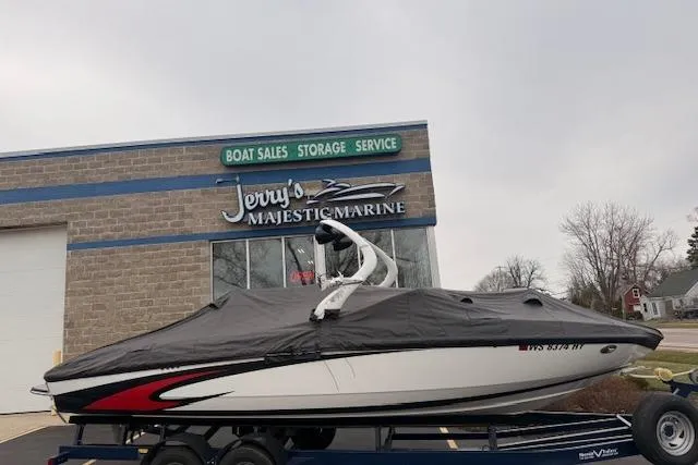Slide: The Image of 2013 Centurion Enzo SV244 boat covered, parked at Jerry's Majestic Marine dealership. - 29