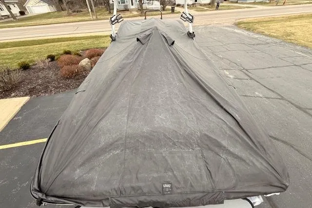 Slide: The Image of 2013 Centurion Enzo SV244 boat covered in a protective tarp on a driveway. - 30