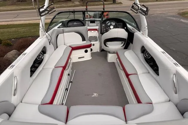 Slide: The Image of 2013 Centurion Enzo SV244 boat interior with white and red seating, steering wheel, and dashboard. - 5