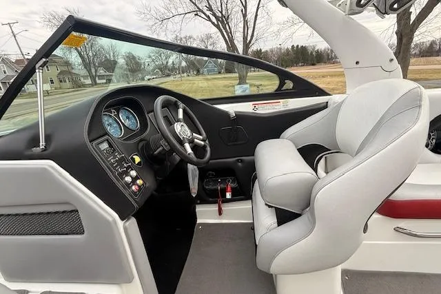 Slide: The Image of 2013 Centurion Enzo SV244 boat interior with steering wheel and dashboard controls. - 6