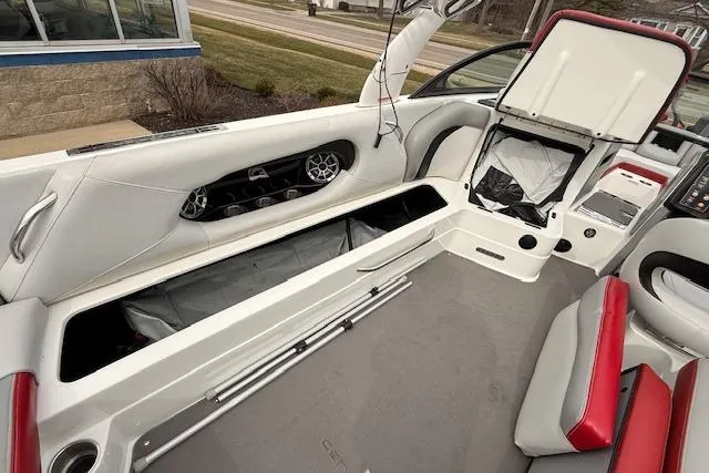 Slide: The Image of 2013 Centurion Enzo SV244 boat interior with open storage compartments and seating. - 9
