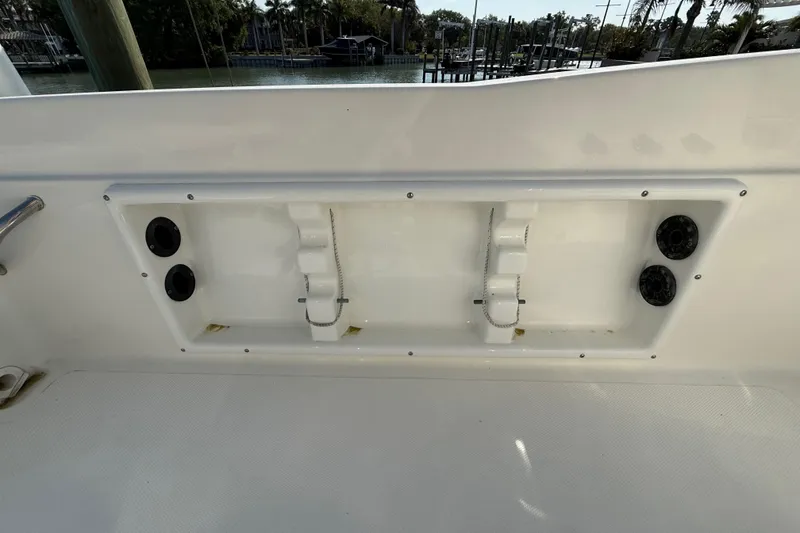 Slide: The Image of 2018 NauticStar 211 Coastal boat interior with rod holders and storage compartment. - 12