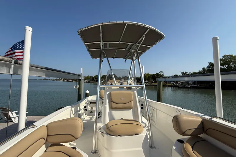 Slide: The Image of 2018 NauticStar 211 Coastal boat with seating, docked by calm waters. - 17