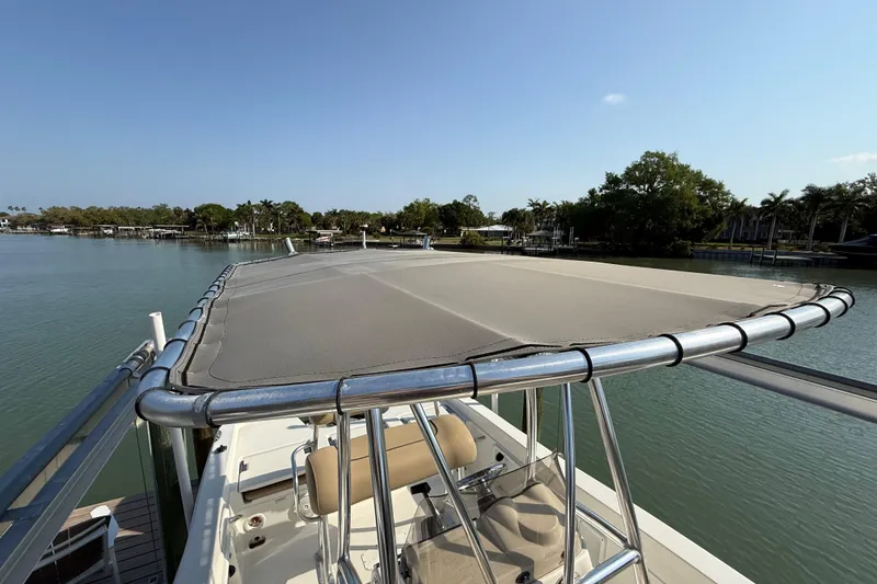 Slide: The Image of 2018 NauticStar 211 Coastal boat with canopy on calm water. - 20