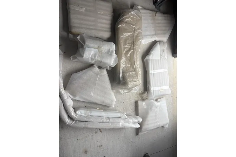 Slide: The Image of Wrapped boat parts for 2018 NauticStar 211 Coastal on a concrete floor. - 22