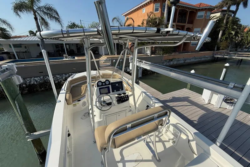 Slide: The Image of 2018 NauticStar 211 Coastal boat docked near waterfront homes. - 8