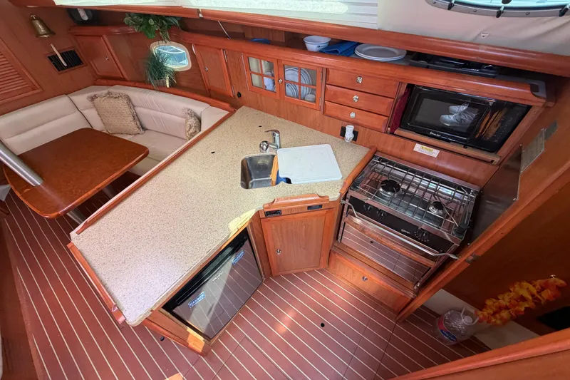 Slide: The Image of Luxurious 2008 Hunter 36 yacht interior with modern kitchen and cozy seating area. - 13