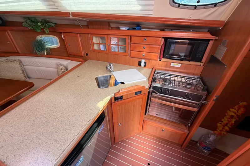 Slide: The Image of Interior of 2008 Hunter 36 sailboat kitchen with stove, sink, and microwave. - 14