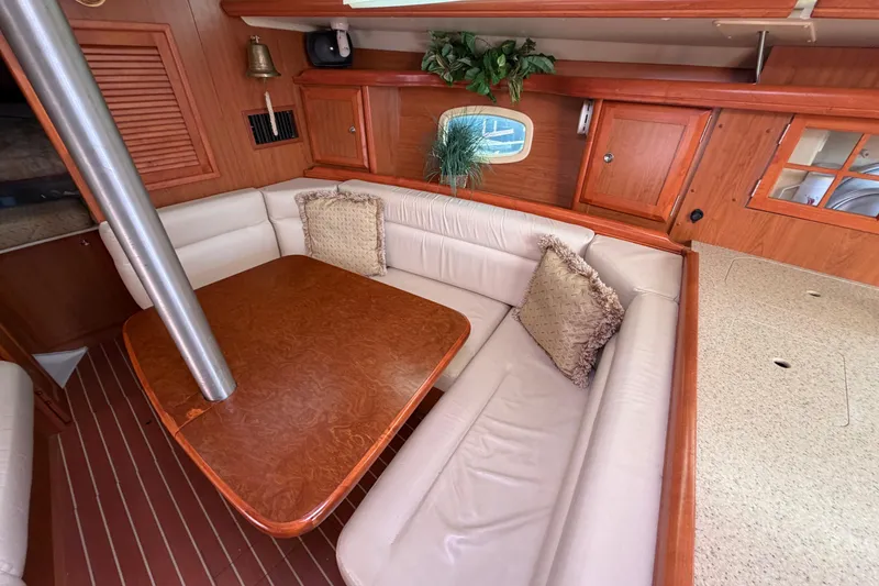 Slide: The Image of Interior of 2008 Hunter 36 sailboat with cozy seating and wooden table. - 16