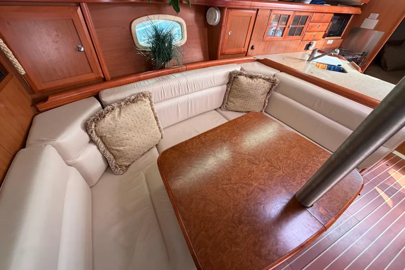 Slide: The Image of Luxurious interior of a 2008 Hunter 36 sailboat with plush seating and wooden table. - 17