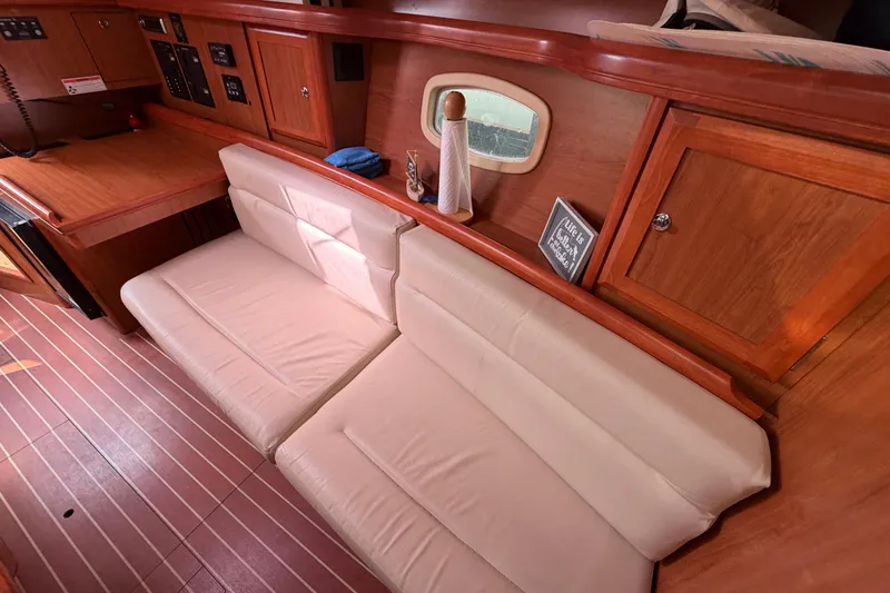 Slide: The Image of Interior of 2008 Hunter 36 sailboat with beige seating and wooden cabinetry. - 18