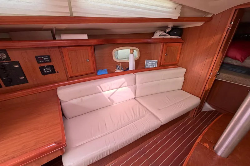 Slide: The Image of Interior of 2008 Hunter 36 sailboat with wooden cabinetry and white seating. - 19