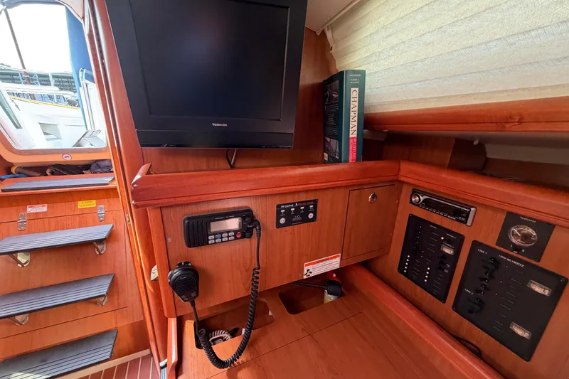 Slide: The Image of Interior of 2008 Hunter 36 sailboat with navigation equipment and TV. - 21
