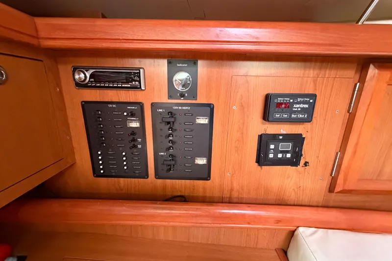 Slide: The Image of Electrical control panel on a 2008 Hunter 36 sailboat, featuring various switches and displays. - 22