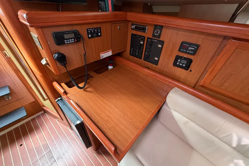 Slide: The Image of Navigation station inside a 2008 Hunter 36 sailboat with control panels and radio equipment. - 23