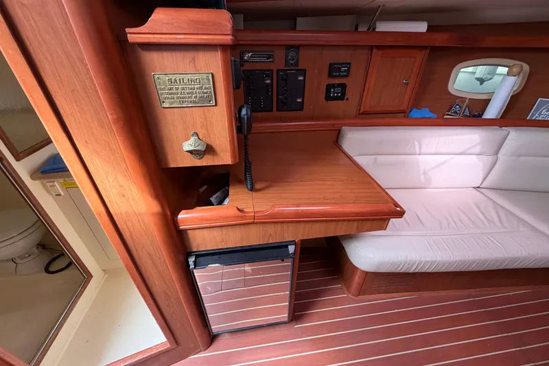 Slide: The Image of Interior of 2008 Hunter 36 sailboat with wooden cabinetry and seating area. - 24