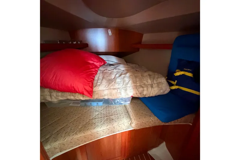 Slide: The Image of Cozy cabin interior of 2008 Hunter 36 sailboat with bedding and life jacket. - 25