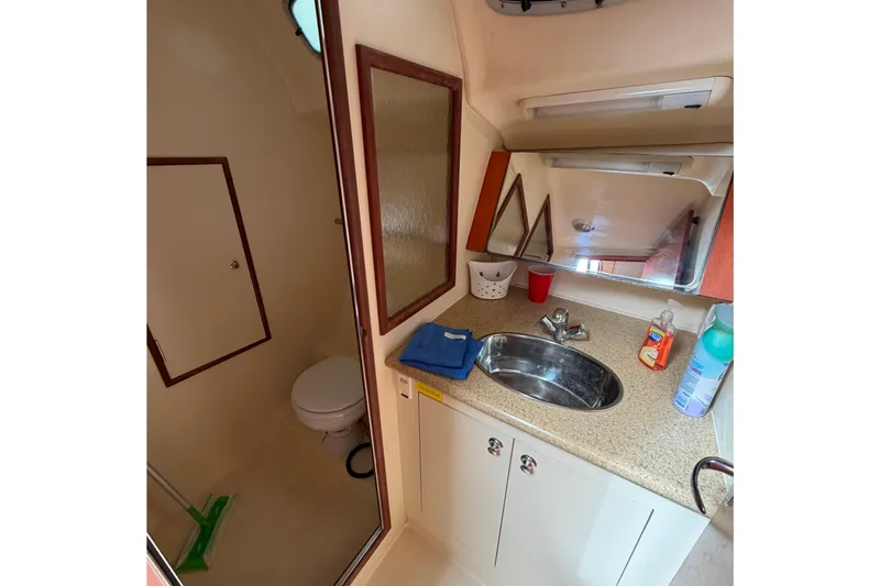 Slide: The Image of 2008 Hunter 36 yacht bathroom with sink, mirror, and toilet. - 26