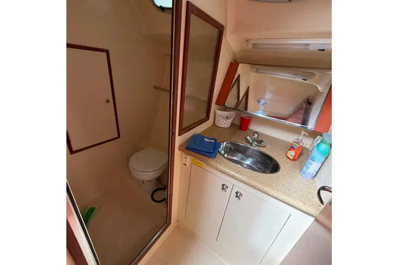 Slide: The Image of Compact bathroom in a 2008 Hunter 36 yacht with sink, mirror, and toilet. - 28