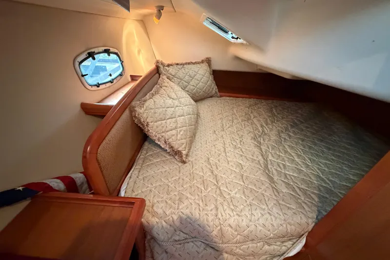 Slide: The Image of Cozy cabin interior of 2008 Hunter 36 sailboat with quilted bedding and porthole. - 29