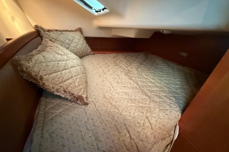 Slide: The Image of Cozy cabin bed in 2008 Hunter 36 sailboat with quilted bedding and pillows. - 30