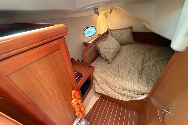 Slide: The Image of Cozy cabin interior of 2008 Hunter 36 sailboat with wood finish and bedding. - 31